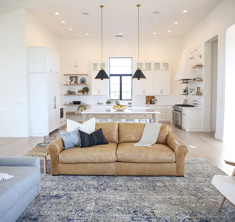 Living Room with kitchen in background, area rug on light hardwood flooring in Hanford, CA