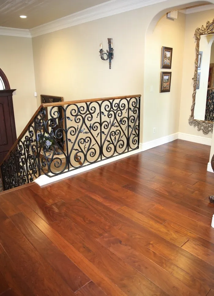 Rich walnut flooring at top of stair landing in Fresno, CA residence