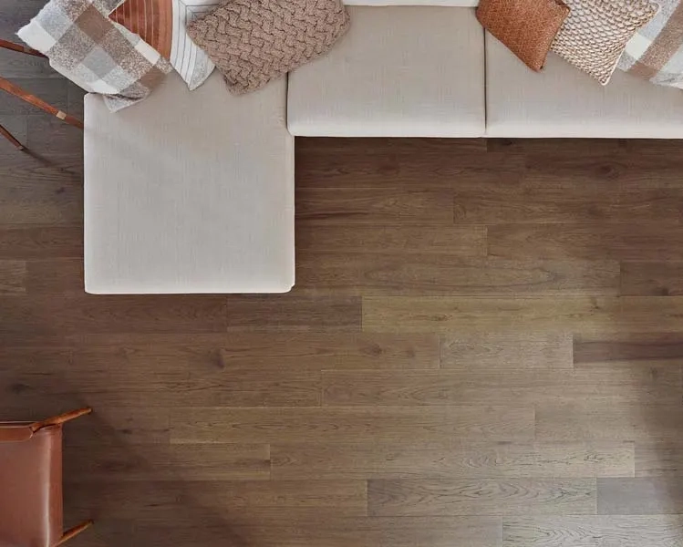 Birdseye view of el-shaped sofa on dark hardwood flooring