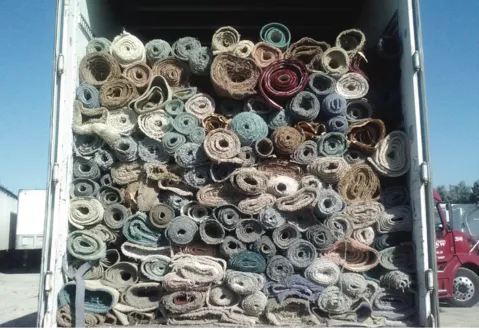 Truck loaded with rolls of old carpeting