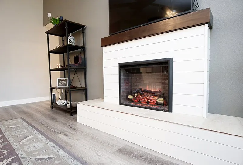 Fireplace set off by beautiful luxury vinyl flooring in Tulare CA home