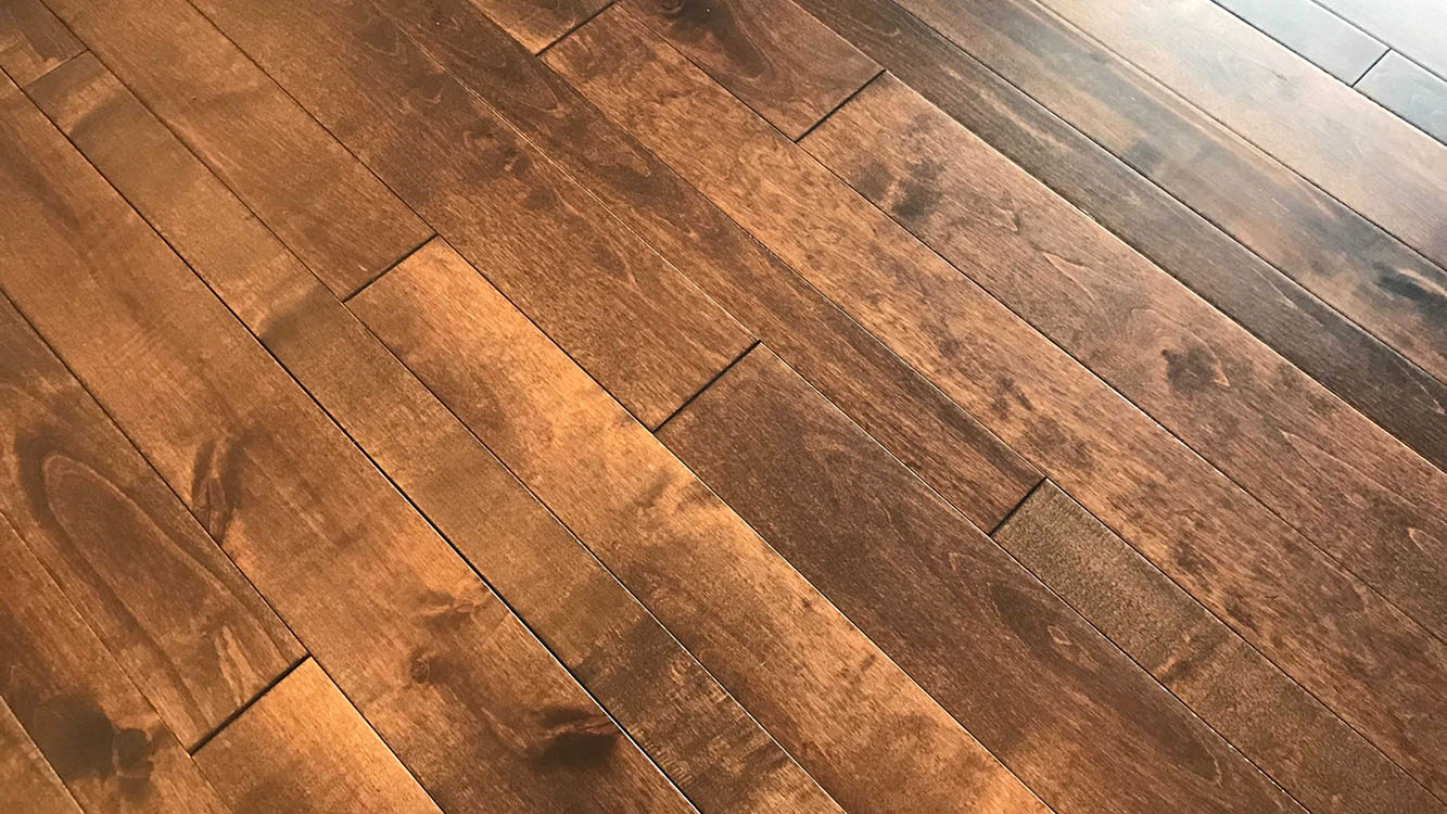 Close up view of rich, dark, handscraped hardwood flooring