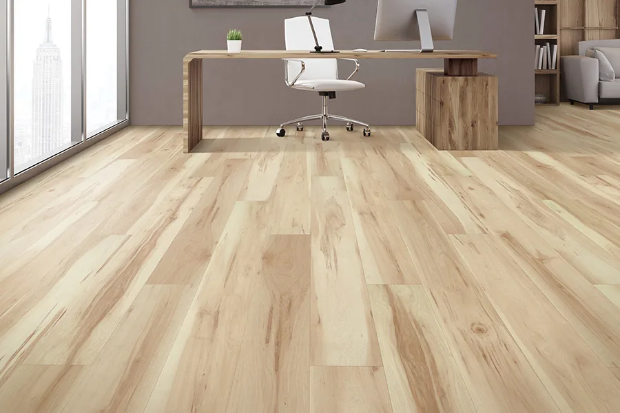 Laminate flooring that looks like sun-bleached hardwood in contemporary office with desk and chair