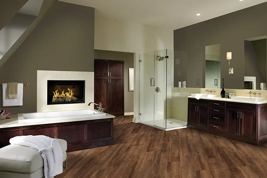 Large master bathroom with dark wood-look laminate flooring