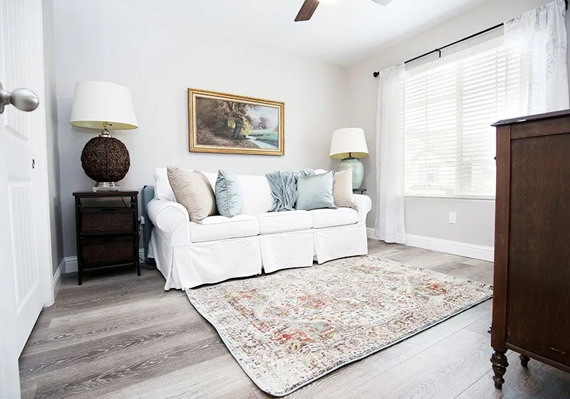 Sitting room with wood-look flooring and area rug