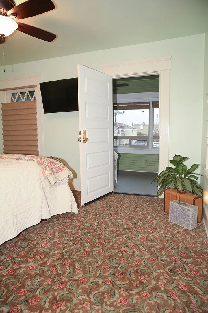 Bedroom with rose, green, and brown floral carpeting, Exeter, CA