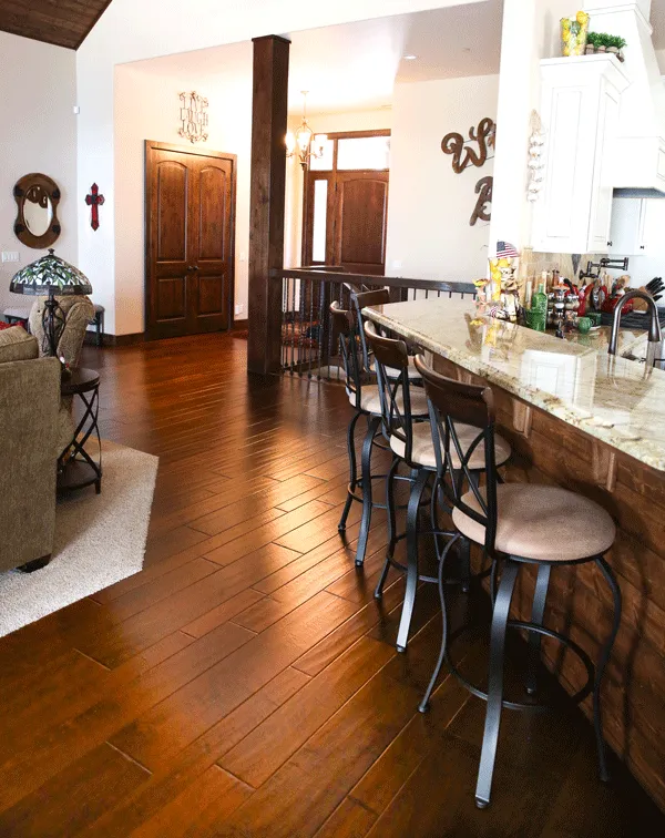 Kitchen counter with bar stools on engineered hardwood flooring in Shaver Lake, CA