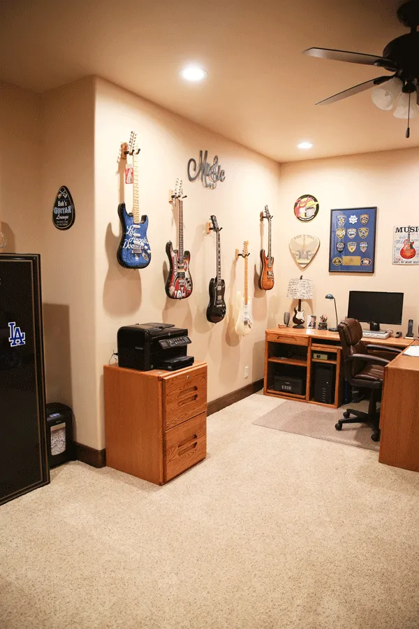 Music room with guitars on wall and office desk