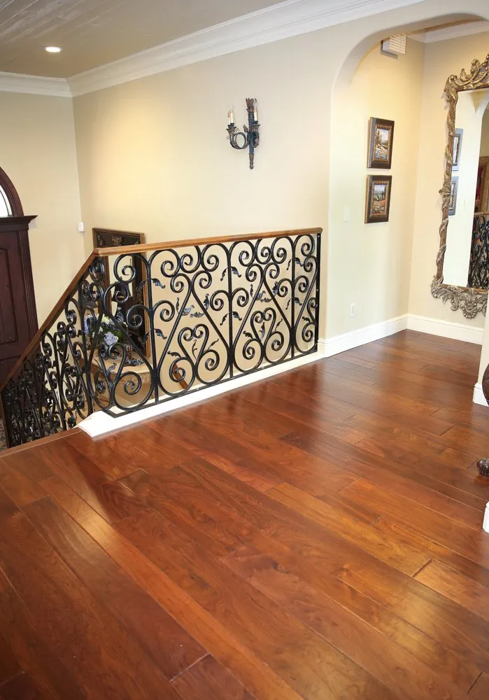 Rich walnut flooring at top of stair landing in Fresno, CA residence