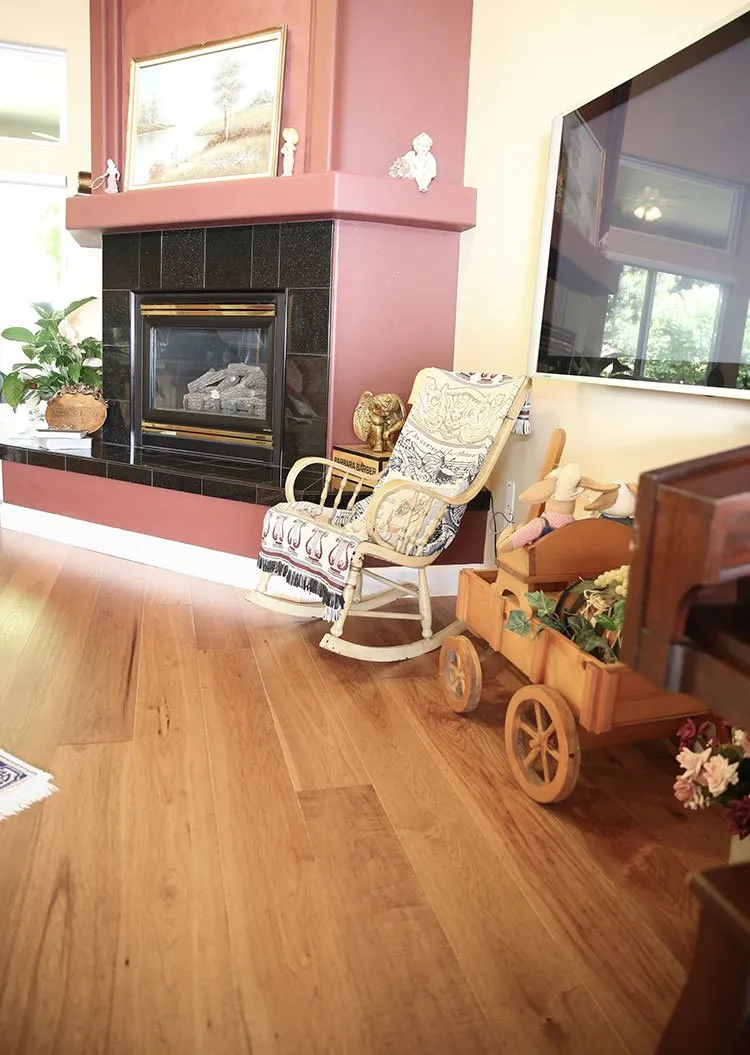 Fireplace in living room with wide hardwood plank flooring
