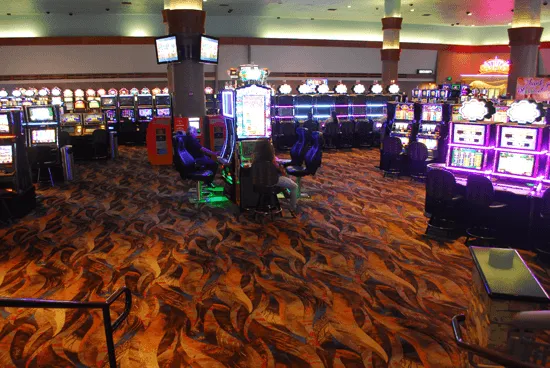 Casino floor filled with slot machines on fiery carpet in Lemoore, CA