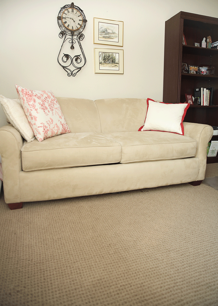 Ivory sofa with two pillows and new carpet