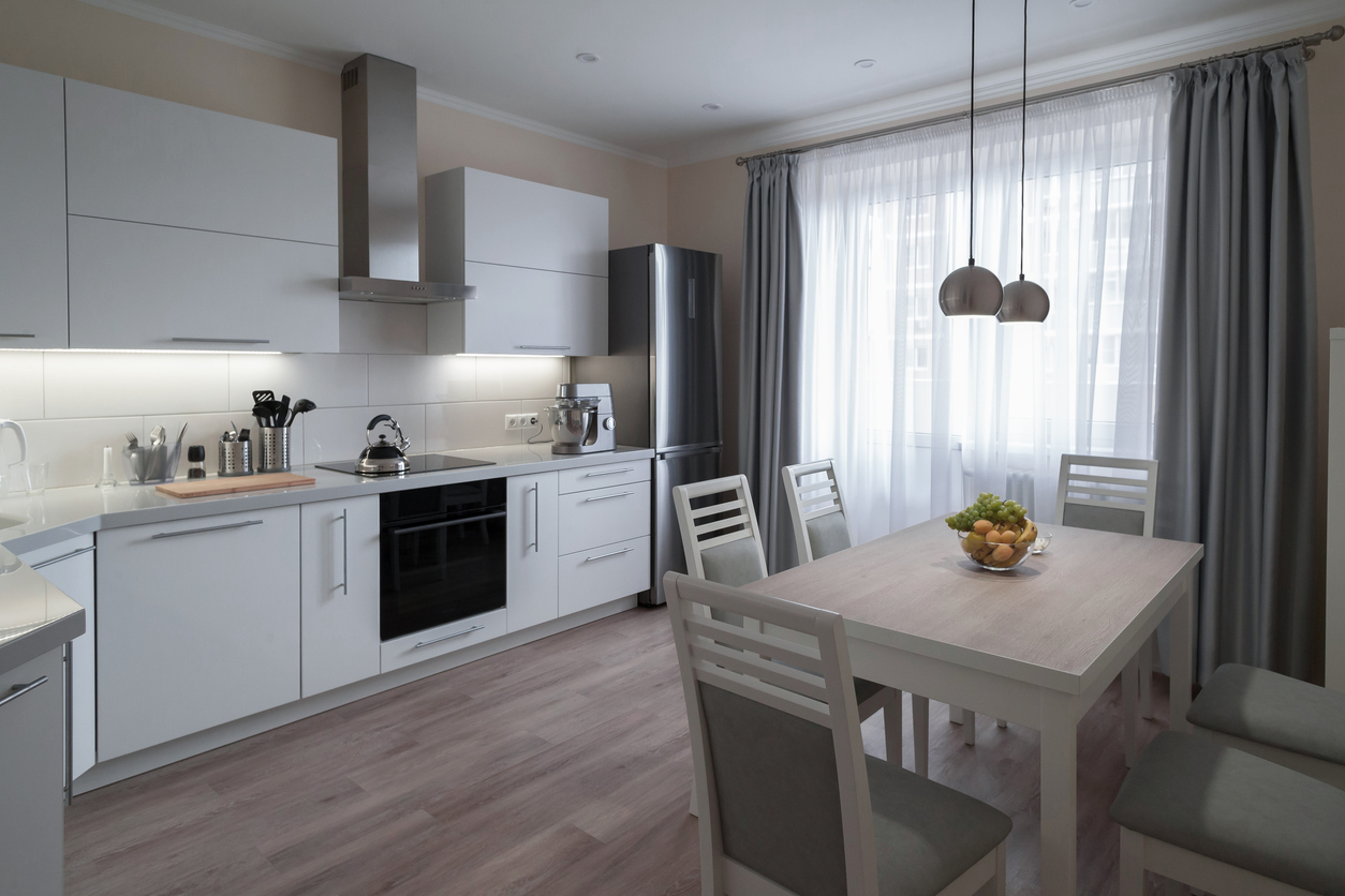 Modern kitchen with table and chairs on wood-look luxury vinyl plank