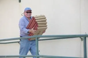 Mike Robinson delivering pizzas to crew