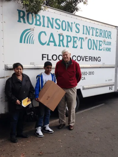 John Corcoran helps deliver computers to students