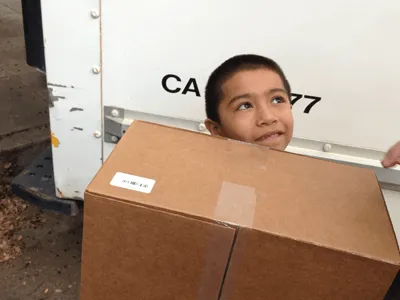 Happy student receiving a computer