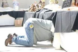 Mike Haile fixing something under a table