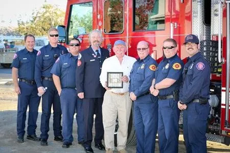 Mike Robinson and local firefighters, with Tunnel 2 Towers representative, Roger Kilfoil, NYFD, who presented Mike with shadow box containing steel from the Twin Towers.